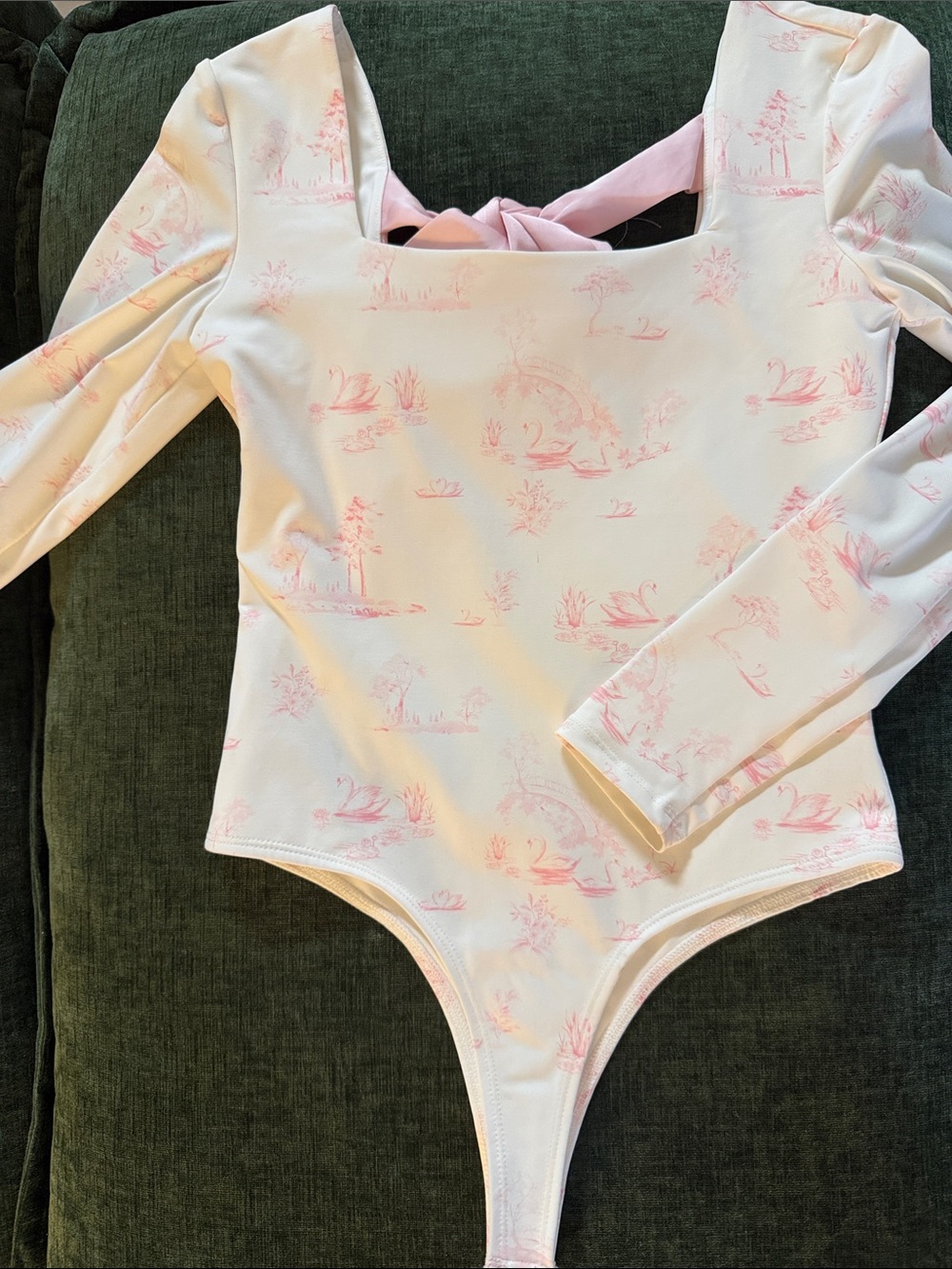 Francesca’s long sleeve bodysuit with open back with pink bow